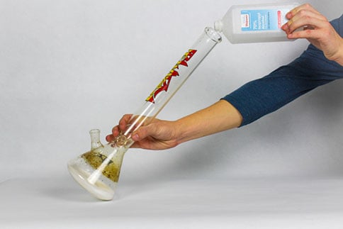 pouring cleaner into the bong