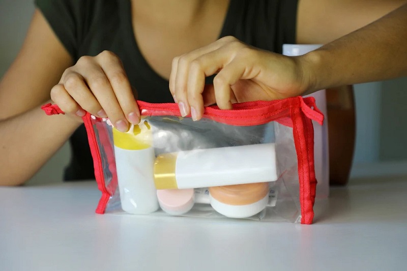 putting liquid containers into a zip lock bag