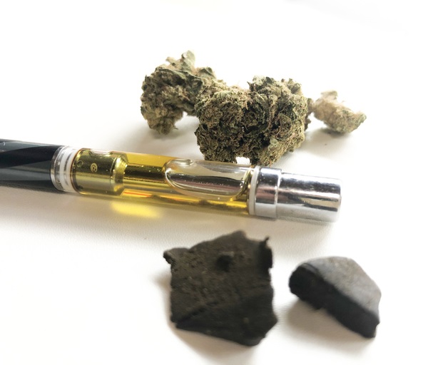 a vape pen with oil cart some cannabis and hash