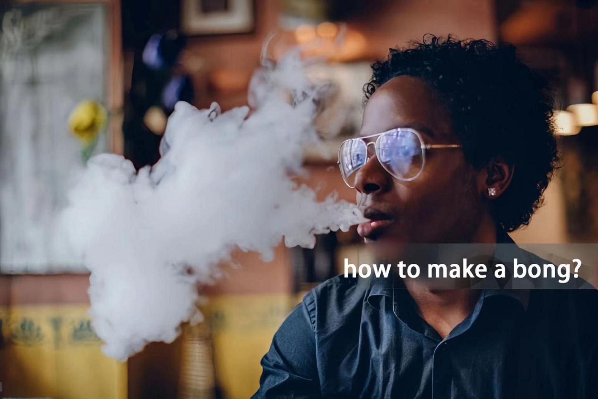 a person with glasses exhaling smoke